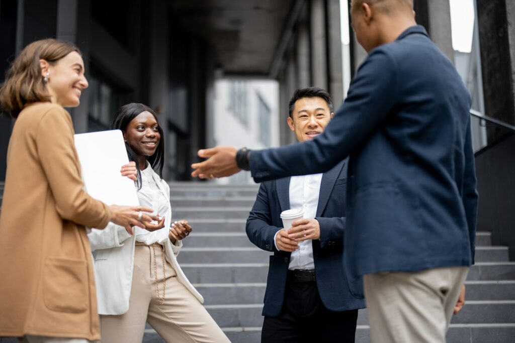 Multiracial business team talking on city street